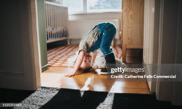 playful toddler - yoga rug stock pictures, royalty-free photos & images