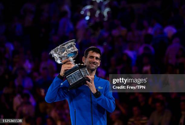 Novak Djokovic of Serbia celebrates with the trophy after beating Rafael Nadal of Spain on day 14 of the 2019 Australian Open at Melbourne Park on...