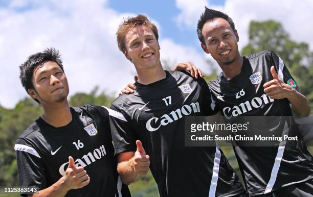 Tsang Chi-hau, Jonathan Carril and Cheng Siu-wai of First Division champions Kitchee pose to the media during their first training session in...