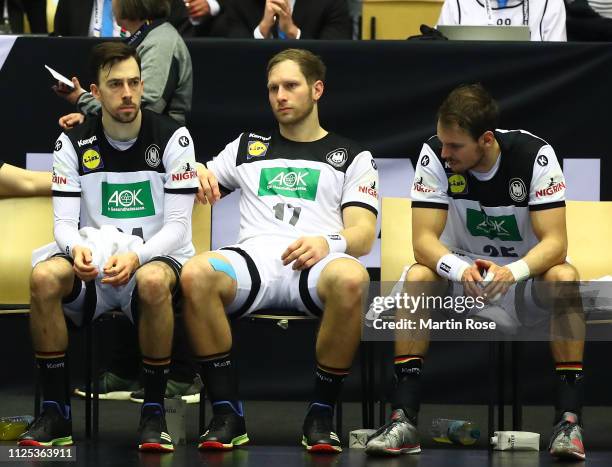 Patrick Groetzki, Steffen Weinhold and Kai Hafner of Germany look dejected after the 26th IHF Men's World Championship 3rd place match between...