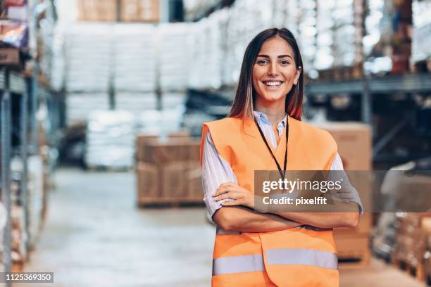 portrait of a young woman in a warehouse - waistcoat stock pictures, royalty-free photos & images