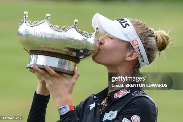 Nelly Korda of the US kisses the winner's trophy following her victory on the final day of the women's LPGA Tour-sanctioned Australian Open golf...