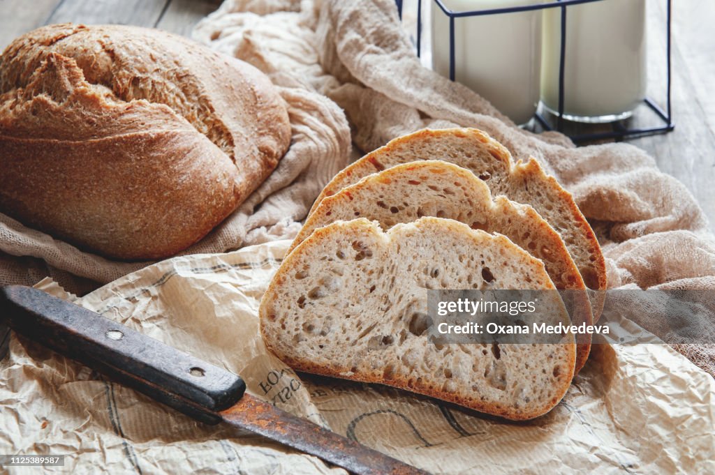 Delicious homemade sourdough rye bread on a plate and milk. Homemade baking