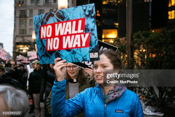 Agirl holds protest sign that reads 'Trump is the emergency' in front of Trump International Hotel on February 15, 2019 in New York City. The group...