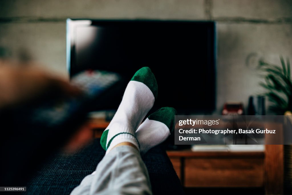 Personal perspective of a woman watching television in a living room