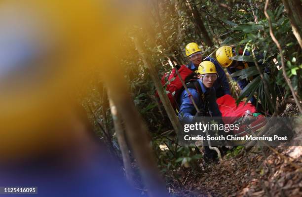 Firefighters carry a wounded person at a inter-departmental vegetation fire cum mountain rescue exercise inside Tai Tam Country Park. 12OCT12