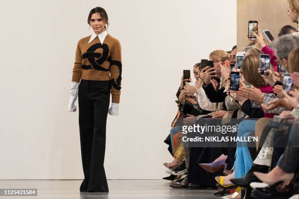 British designer Victoria Beckham acknowledges the crowd during her 2019 Autumn / Winter collection catwalk show at London Fashion Week in London on...
