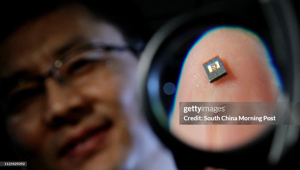 Professor Xue Quan, Associate Vice-president of City University of Hong Kong  (CityU) showing a high - speed wireless data transceiver system which the university receives HK $20 million to develop during the press conference in CityU campus, Kowloon Tong