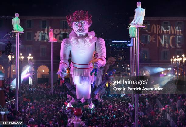 Giant statue of US President Donald Trump depicted as an evil clown holding a French President Emmanuel Macron's puppet in his hand parade during the...