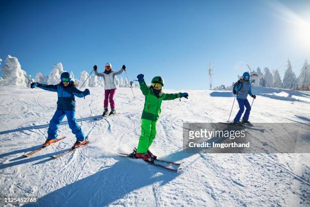 familie plezier samen skiën op de winterdag - female skier stockfoto's en -beelden
