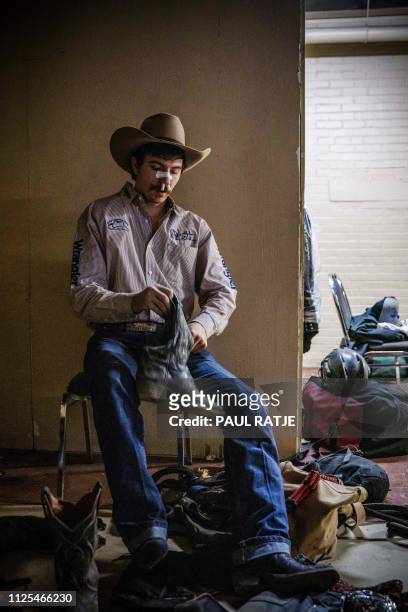 Rider Roscoe Jarboe of New Plymouth Idaho gets changed after the Tuff Hedeman Bull Riding Tour at the El Paso County Colosseum on February 16, 2019....