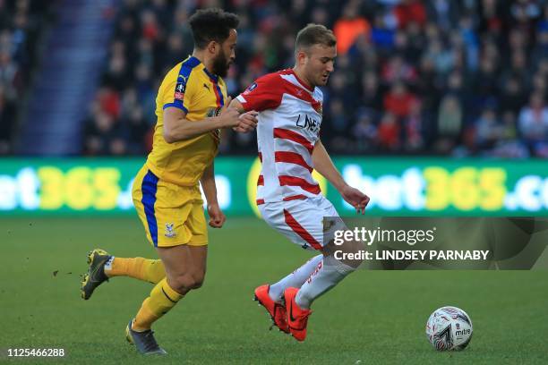 Doncaster Rovers' English midfielder Herbie Kane vies with Crystal Palace's English midfielder Andros Townsend during the English FA Cup fifth round...