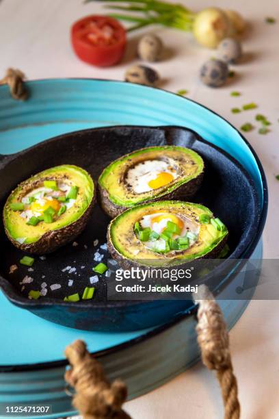 avocado baked with quail eggs - table top imagens e fotografias de stock