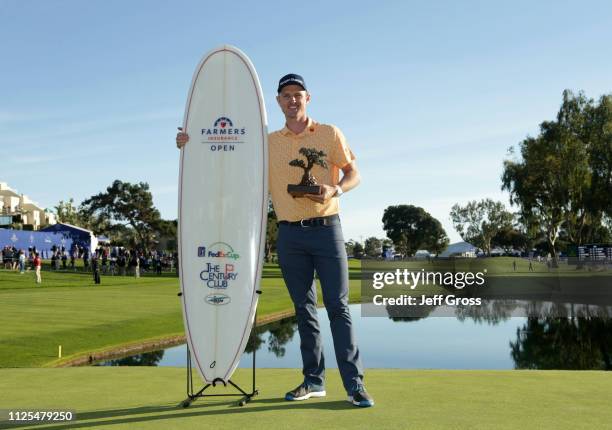 Justin Rose of England poses with the trophy after winning on the South Course during the final round of the the 2019 Farmers Insurance Open at...