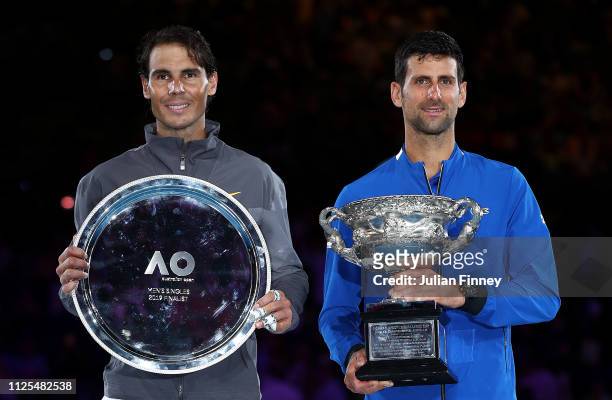 Novak Djokovic of Serbia poses with the Norman Brookes Challenge Cup following victory in his Men's Singles Final match along side runner up Rafael...