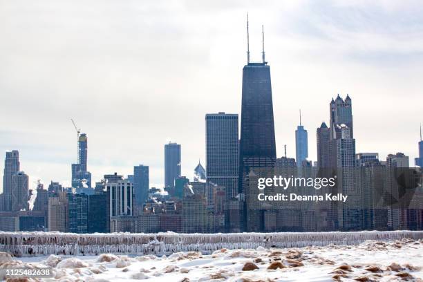 chicago skyline on icy winter day - chicago winter snow stock pictures, royalty-free photos & images