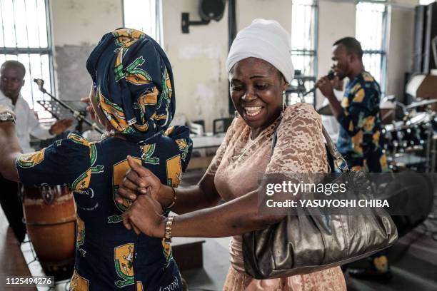 Worshippers dance with music during Sunday service at St. Mary's Cathoric church in Port Harcourt, Southern Nigeria, on February 17. 2019.