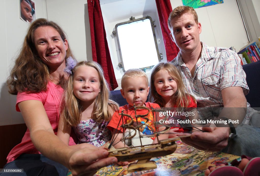 Matthew Blair, wife Heidrun Blair, and their three kids Rebecca (age 7), Amy (age 5 / red dress) and James (age 3), pose for photos on Logos Hope - the ship which carries the world's largest floating library, now docked at China Merchants Wharf, Kennedy T