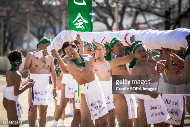 Naked men seen dedicating a colorful bamboo during the festival. Traditional naked festival in Inazawa, Aichi prefecture, Japan also called the...