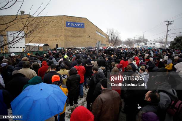People attend a prayer vigil outside Henry Pratt Company on February 17, 2019 in Aurora, Illinois. Six people including a gunman were killed and 5...