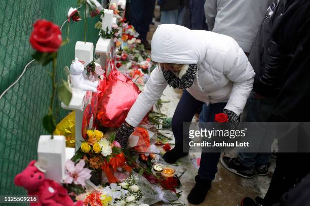 Woman places flowers at a makeshift memorial outside Henry Pratt Company on February 17, 2019 in Aurora, Illinois. Six people including a gunman were...