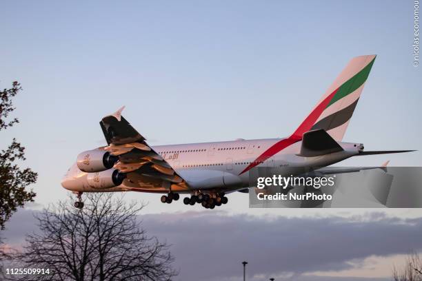 Emirates Airbus A380 shown landing at London Heathrow International Airport LHR / EGLL in England, UK over the residential area of Myrtle Avenue. The...