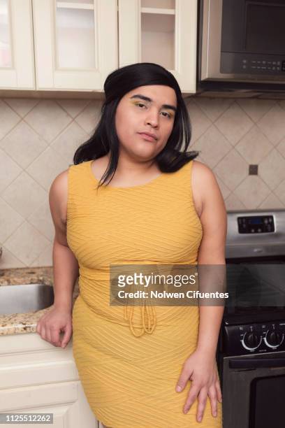 Portrait of young woman in kitchen