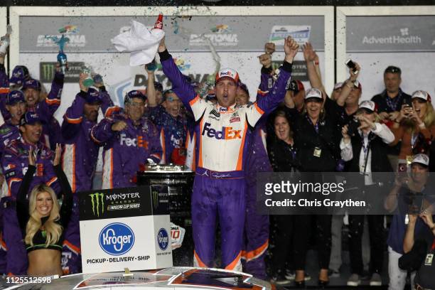 Denny Hamlin, driver of the FedEx Express Toyota, celebrates in victory lane after winning the Monster Energy NASCAR Cup Series 61st Annual Daytona...