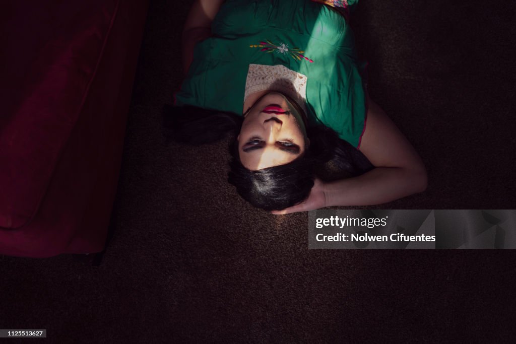 Portrait of young woman with light across face