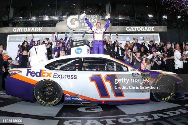 Denny Hamlin, driver of the FedEx Express Toyota, celebrates in victory lane after winning the Monster Energy NASCAR Cup Series 61st Annual Daytona...