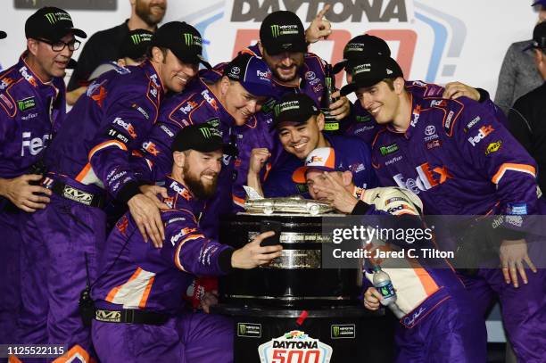 Denny Hamlin, driver of the FedEx Express Toyota, takes a selfie with his crew memebrs in Victory Lane after winning the Monster Energy NASCAR Cup...