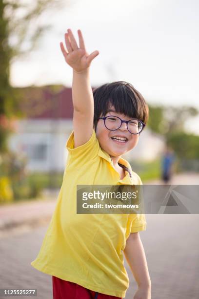 5 years old young boy waving. - child waving stock pictures, royalty-free photos & images