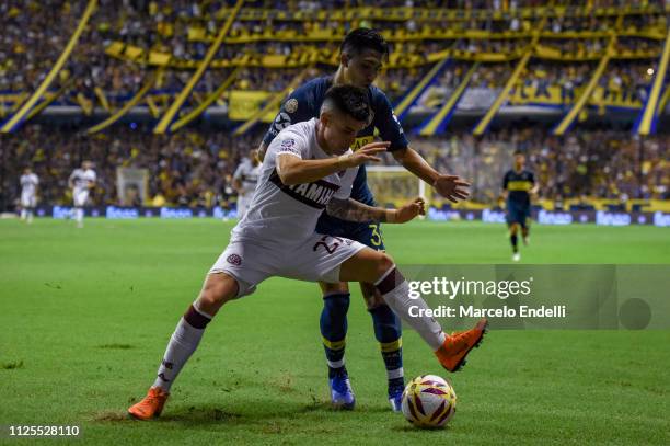 Emanuel Reynoso of Boca Juniors fights for the ball with Gabriel Carrasco of Lanus during a match between Boca Juniors and Lanus as part of Superliga...