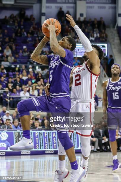 Horned Frogs guard Kendric Davis drives towards the basket as Oklahoma Sooners guard Aaron Calixte tries to defend during the game between the TCU...