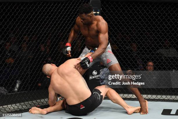 Francis Ngannou of Cameroon knocks down Cain Velasquez in their heavyweight bout during the UFC Fight Night event at Talking Stick Resort Arena on...