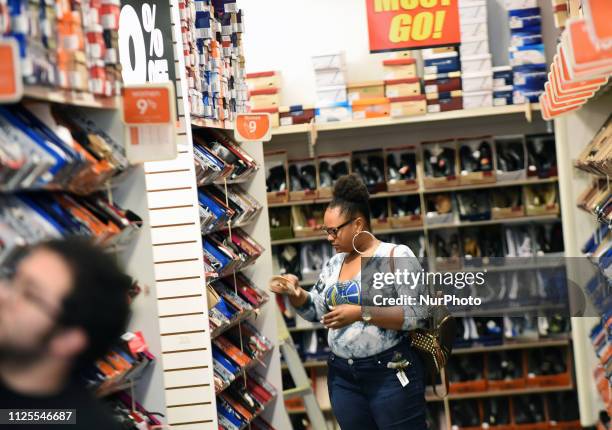 February 17, 2019 - Orlando, Florida, United States - A woman shops at a Payless ShoeSource store in Orlando, Florida on February 17 the first day of...