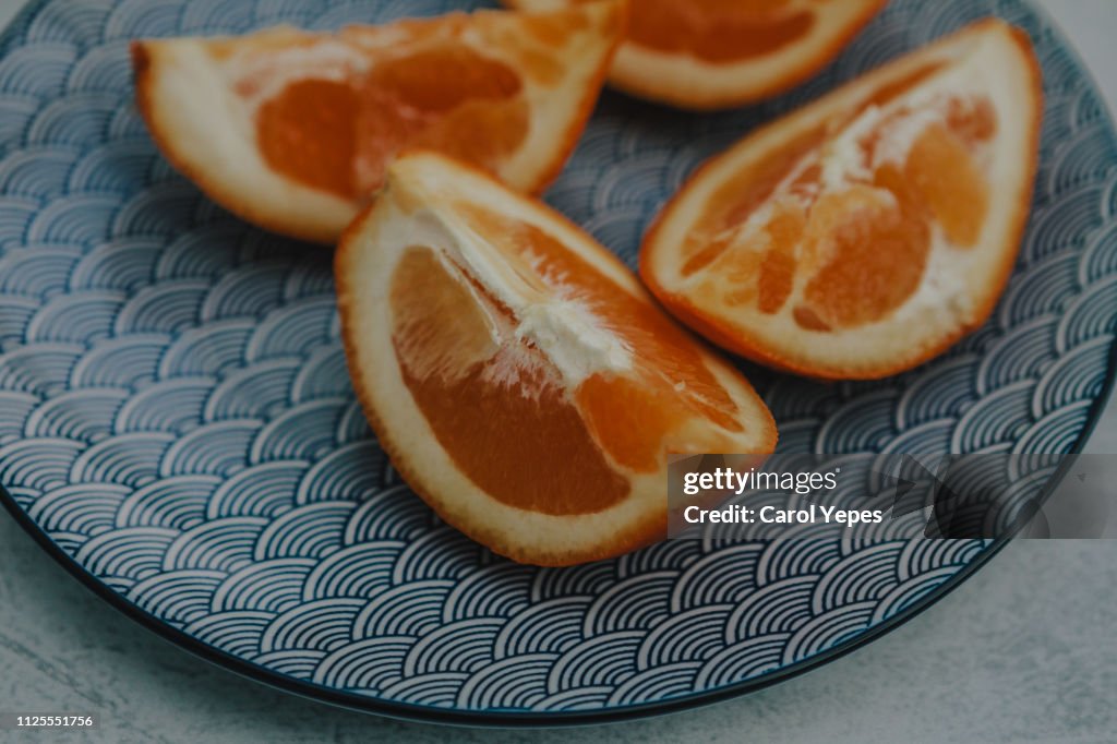 Orange slices on blue ceramic plate