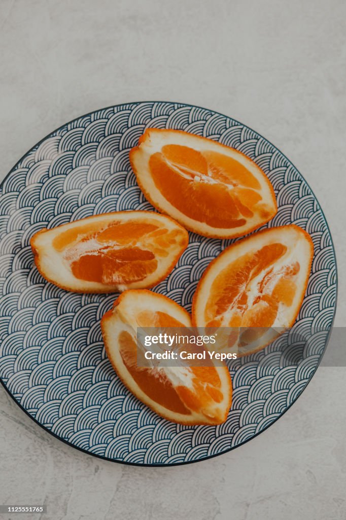 Orange slices on blue ceramic plate
