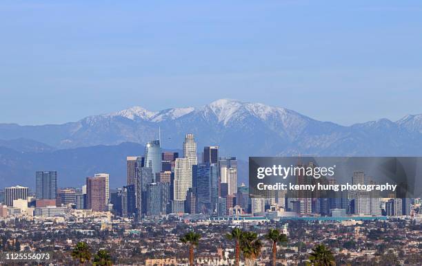 skyline of los angeles with snowcapped moutain as background - los angeles skyline stock pictures, royalty-free photos & images