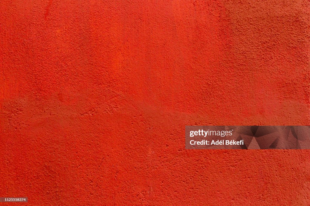 Red plastered rusty concrete wall