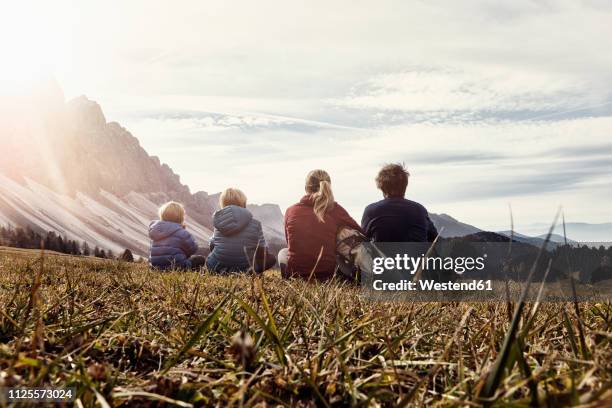 italy, south tyrol, geissler group, family hiking, sitting on meadow - dolomites stock pictures, royalty-free photos & images