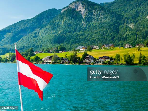 austria, salzkammergut, salzburg state, lake wolfgangsee, st. wolfgang, holiday homes and austrian flag - austria flag stock pictures, royalty-free photos & images