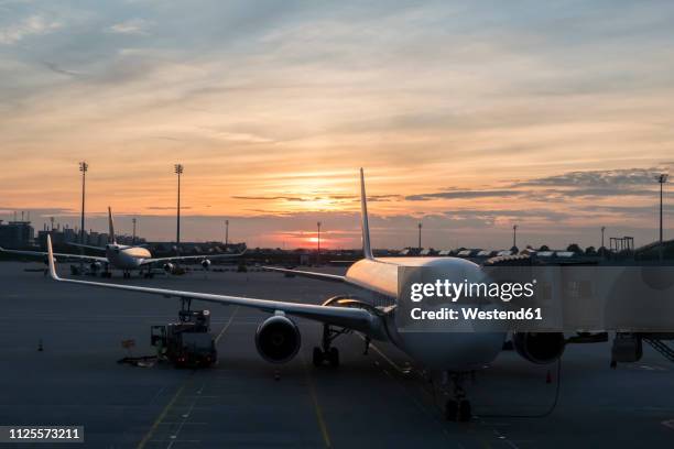 germany, bavaria, munich, airport at sunset - munich airport stock-fotos und bilder