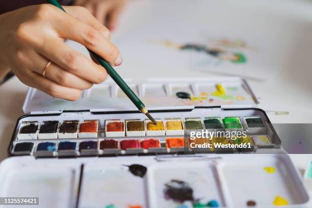 illustrator painting at work desk, close-up - watercolour paints stock-grafiken, -clipart, -cartoons und -symbole