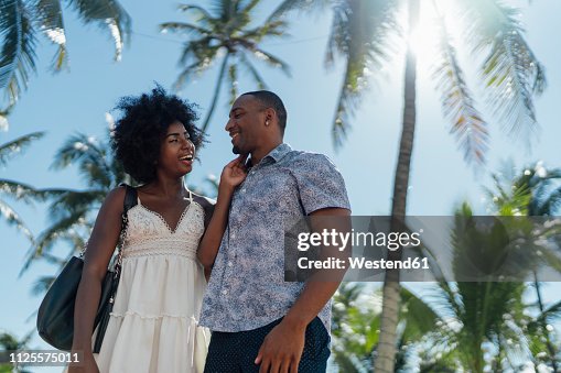 USA, Florida, Miami Beach, happy young couple at palm trees in summer USA, Florida, Miami Beach, happy young couple at palm trees in summer