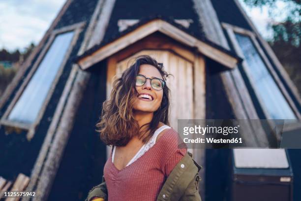 portrait of a laughing young woman infront of a finnish house - inari finland stock pictures, royalty-free photos & images