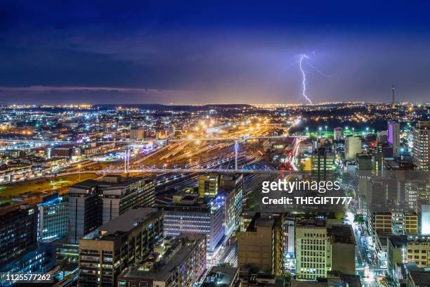 johannesburg storm and lightning with nelson mandela bridge - nelson mandela bridge stock pictures, royalty-free photos & images