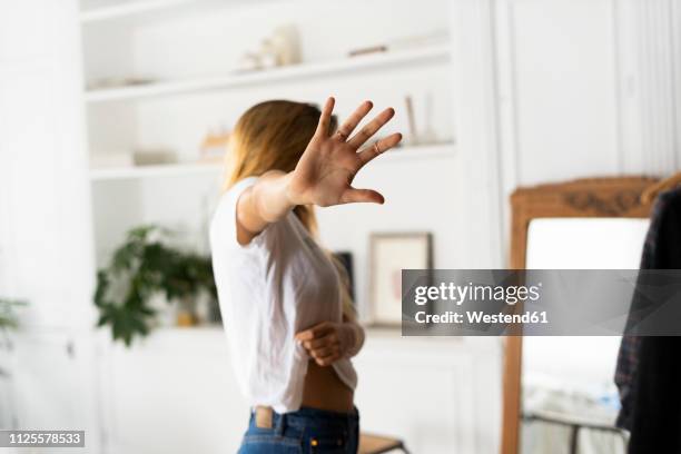 abuse and violence against women, woman raising hand at home - domestic violence home stock pictures, royalty-free photos & images