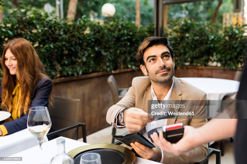 Man paying with credit card in a restaurant