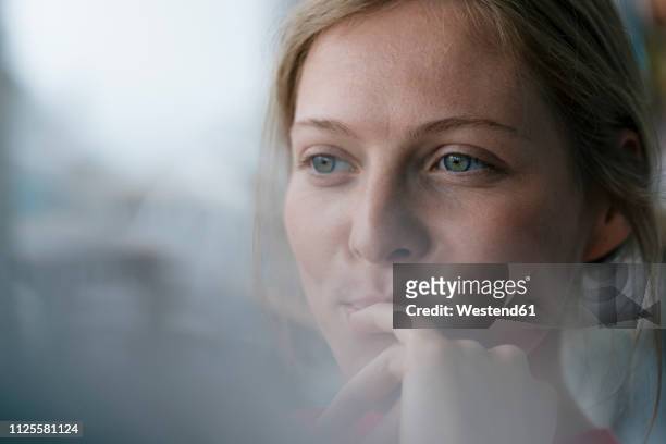 portrait of smiling young woman looking sideways - reflection stock-fotos und bilder